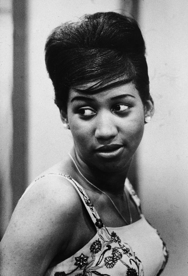 Aretha Franklin looks over her shoulder, her hair pulled up into a beehive style, 1961. Photo by Metronome/Getty Images)