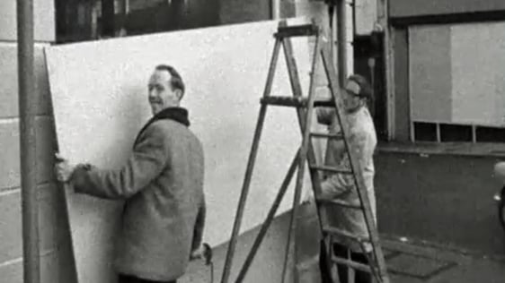 Shopkeepers in Armagh remove hoardings after civil rights demonstration.