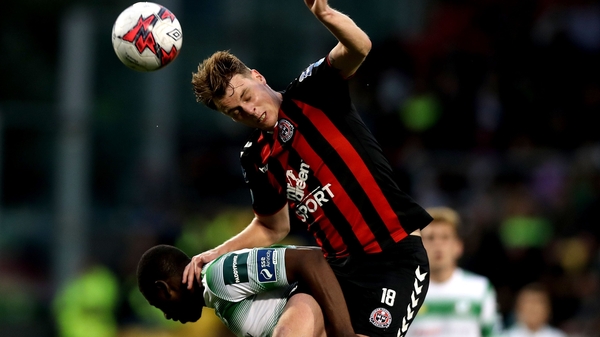 Rovers' Dan Carr rises with Ian Morris of Bohemians