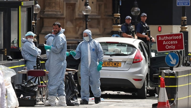 Forensics officers work around the silver Ford Fiesta car that was driven into a barrier at Westminster