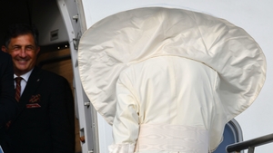 Windswept - A gust of wind blows the Pope's mantle as he boards his flight from Rome to Dublin