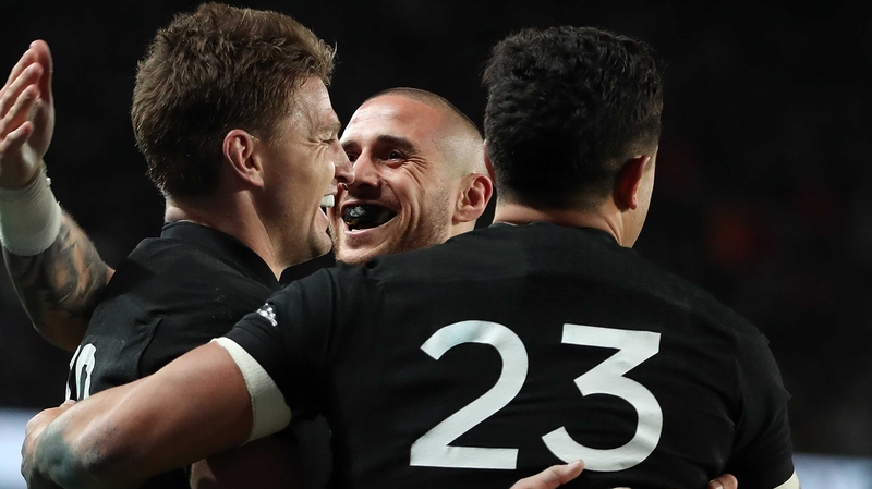 TJ Perenara (C) congratulates Beauden Barrett (L)