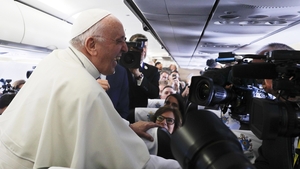The Pope laughs while speaking to journalists on the flight to Dublin