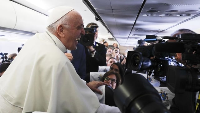 The Pope laughs while speaking to journalists on the flight to Dublin