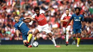 Jack Wilshere of West Ham United battles for posession with Alex Iwobi of Arsenal