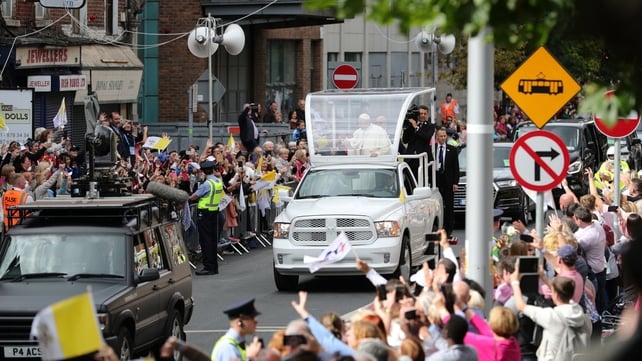 Pope Francis waves to the crowds on his way to the Capuchin Day Centre