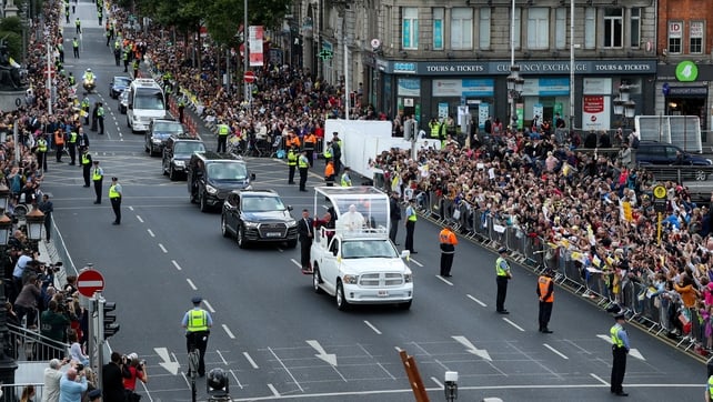 Thousands line the streets as the Popemobile makes its way through the city centre