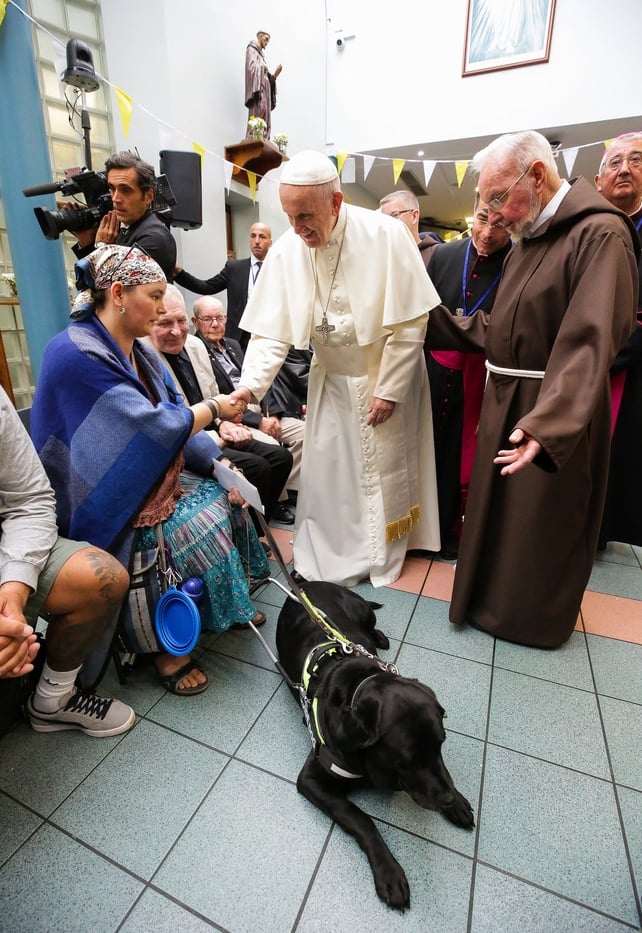 Pope Francis shakes hands with Rosemary Fearson and her guide dog, Kia. Also pictured is Br Kevin Crowley, at the Capuchin Day Centre