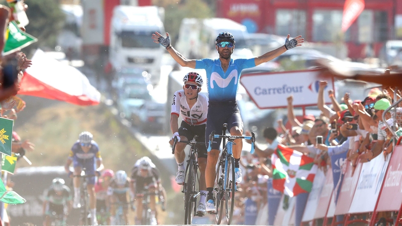 Alejandro Valverde raises his arms in celebration at the finish line