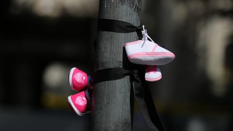 Baby shoes hang at a mother-and-baby homes protest in Dublin