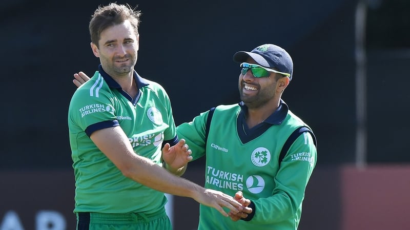 Ireland's Tim Murtagh (L) celebrates after dismissing Gulbadin Naib of Afghanistan