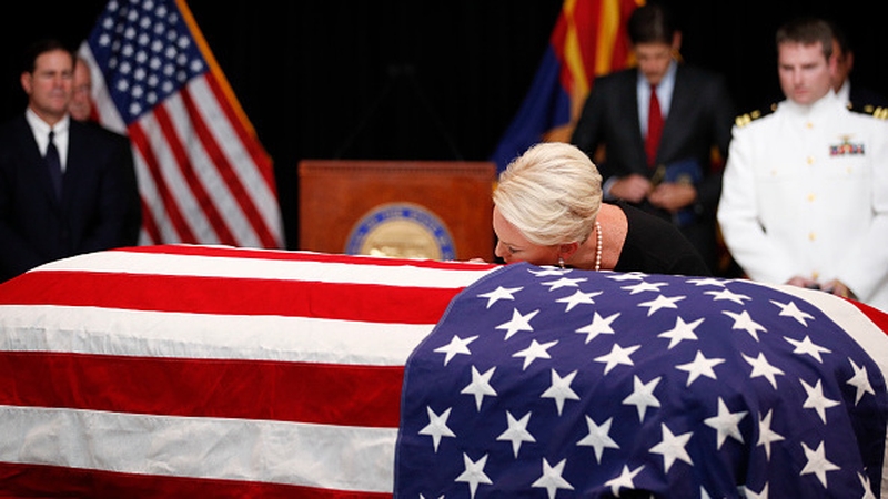 Cindy McCain kisses her late husband's casket during the memorial service
