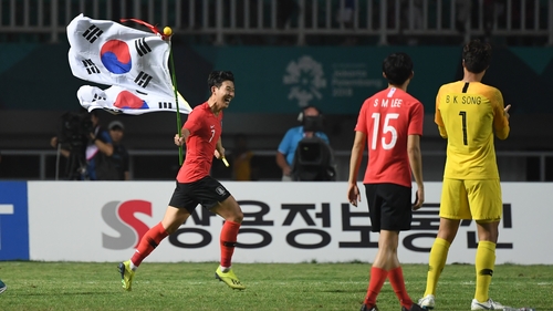 Heung Min Son celebrates after winning against Japan