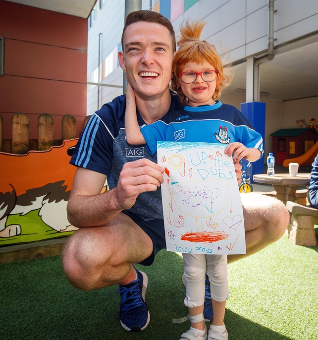 Brian Fenton is given a drawing by Zoe Lonergan, 6 from Firhouse