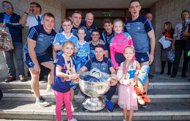 Members of the Dublin team with young fans and the Sam Maguire outside Our Lady's Children's Hospital Crumlin