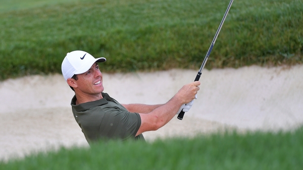 Rory McIlroy plays a shot from the ninth-hole bunker