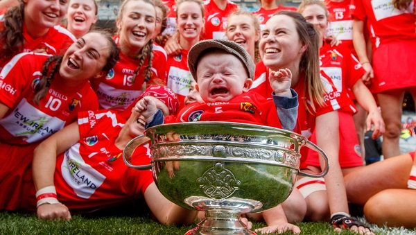 Briege Corkery's five-month old son Tadhg joins the victorious Cork team with the O'Duffy Cup