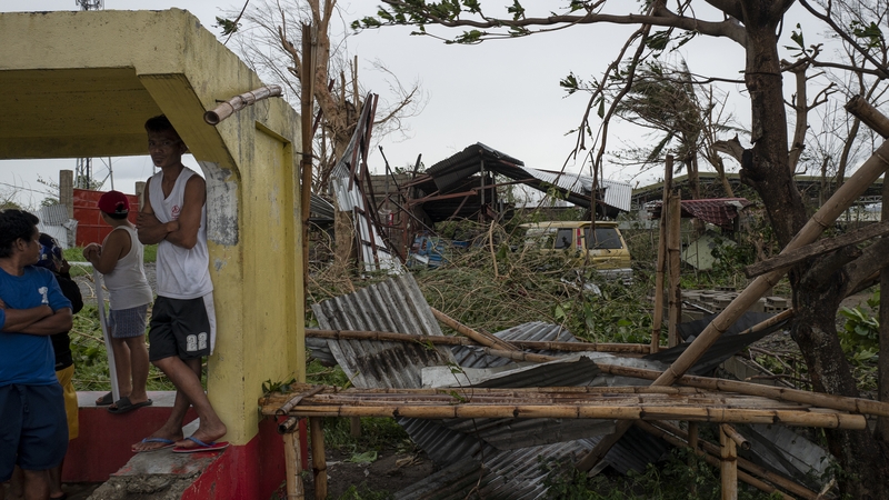 Tens of thousands of people were evacuated from coastal areas following warnings of possible storm surges of 3-6m