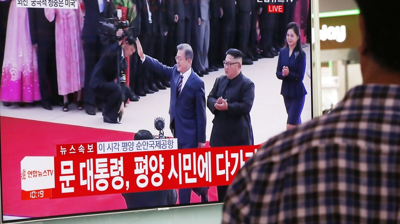 A South Korean watches TV footage of North Korean leader Kim Jong-un welcoming South Korean President Moon Jae-in