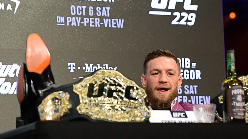 McGregor rests his feet on the table