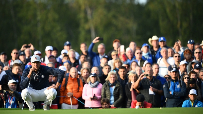 US golfer Brooks Koepka lines up a putt at Le Golf National Course