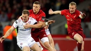 Munster's Andrew Conway battles with Darren Cave of Ulster
