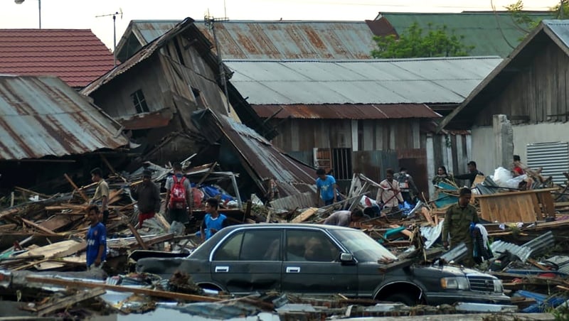 Residents try to salvage belongings after the earthquake left buildings collaposed
