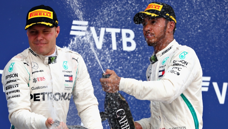 Lewis Hamilton (R) and Mercedes team-mate Valtteri Bottas celebrate on the podium