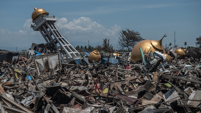 Rubble and debris lie around the ruins of a mosque in Palu