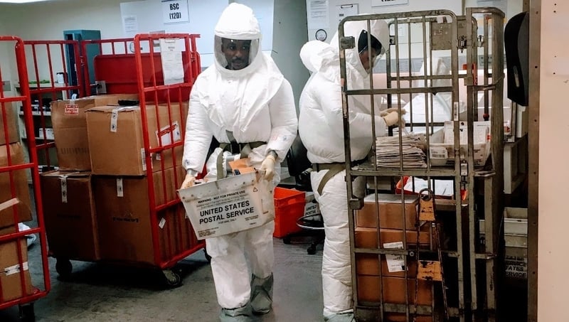US Defense Department personnel, wearing protective suits, screen mail as it arrives at the Pentagon