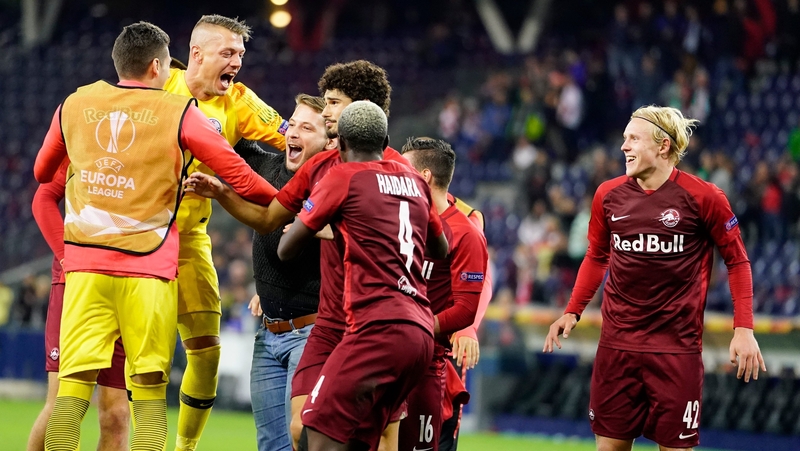 Alexander Walke, Andre Ramalho, Xaver Schlager and a Salzburg fan celebrate their victory against Celtic