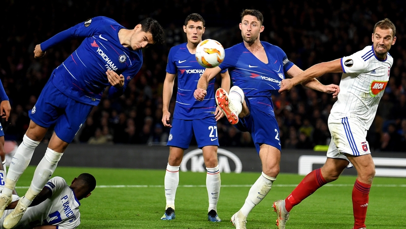 Alvaro Morata and Gary Cahill of Chelsea stretch for the ball