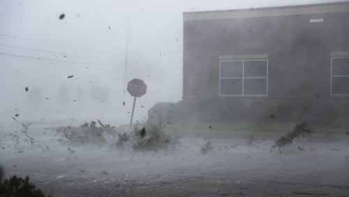 Debris is blown down a street by Hurricane Michael in Panama City, Florida