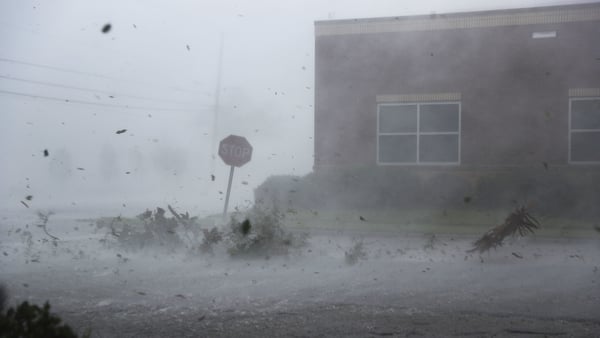 Debris is blown down a street by Hurricane Michael in Panama City, Florida