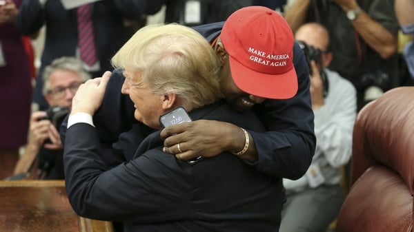 Kanye West and Donald Trump embrace in the Oval Office