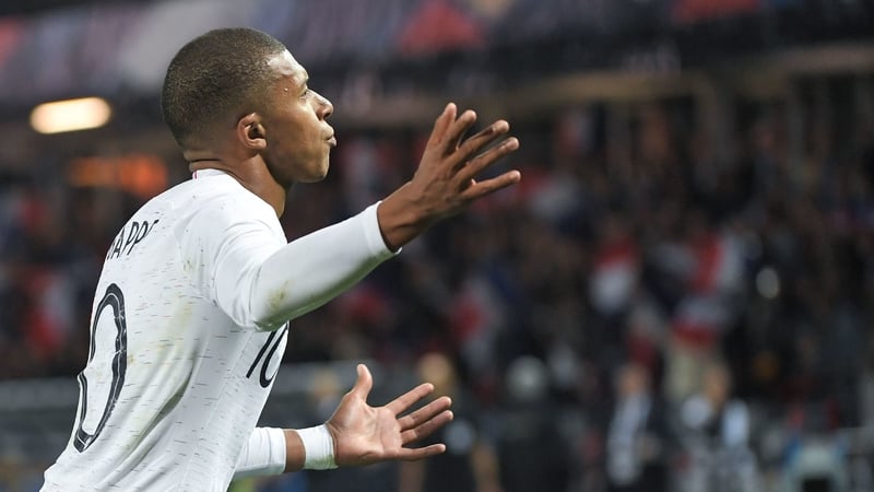 Kylian Mbappe celebrates after scoring a late penalty