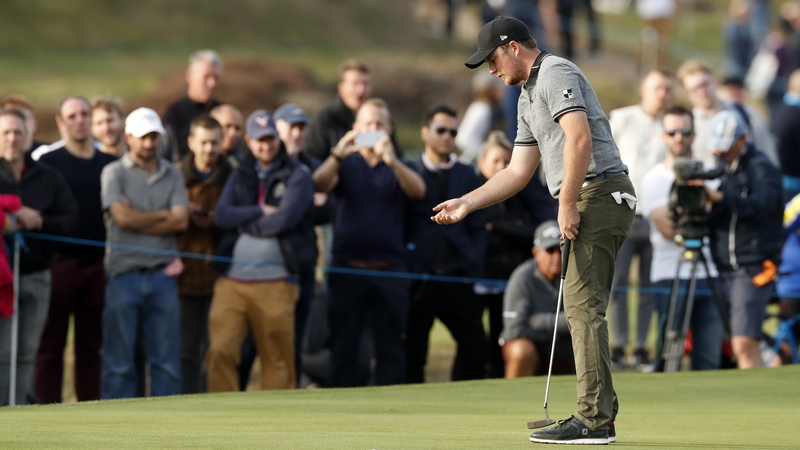 The Englishman gets ready to make a putt on the 14th