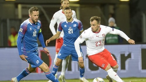 Iceland's midfielder Gylfi Sigurdsson (L) tries to close down Switzerland's Xherdan Shaqiri