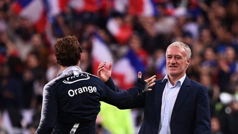 Antoine Griezmann celebrates with coach Didier Deschamps