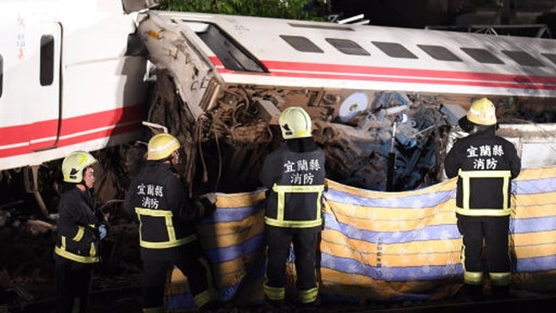 Rescue teams work to remove those injured in the derailment