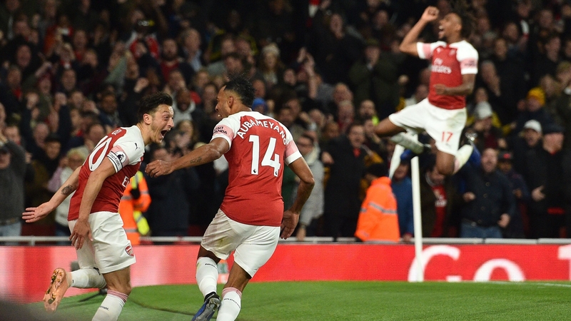 Pierre-Emerick Aubameyang (2nd L) celebrates with Arsenal's German midfielder Mesut Ozil (L)