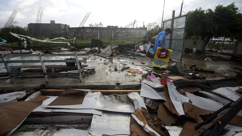 A resident salvages belongings from the rubble of a building in the city of Escuinapa in Sinaloa state