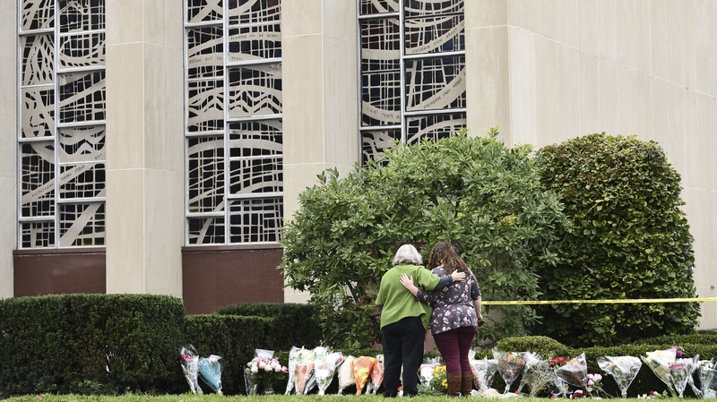 Women embrace at a memorial outside the Tree of Life Synagogue in Pittsburgh