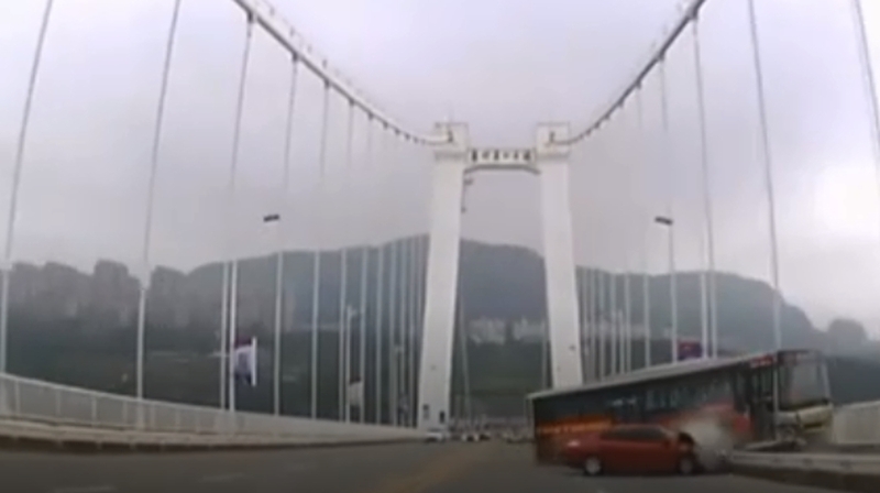 The bus hit a car before breaking through the rails of the bridge crossing the Yangtze River