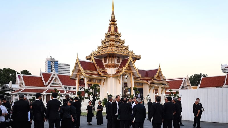 Mourners arrive at the Wat Thepsirin Buddhist temple in Bangkok for the funeral ceremony of Vichai Srivaddhanaprabha
