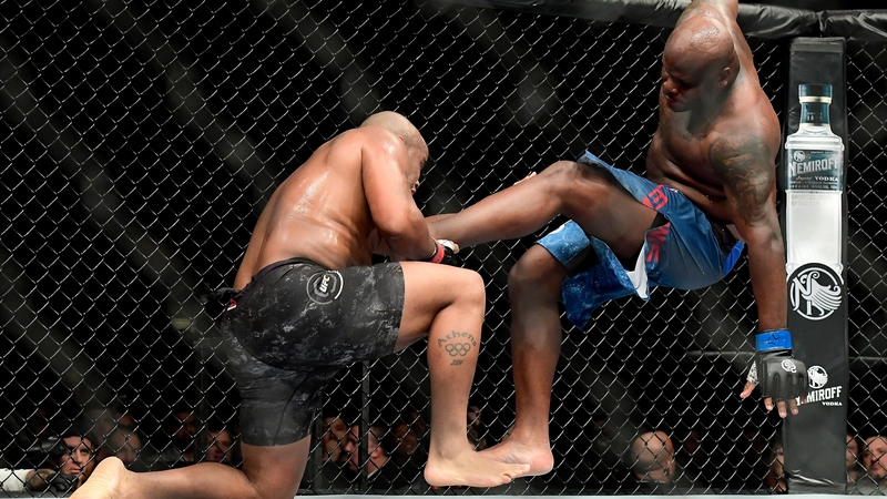 Derrick Lewis (r) is taken down by Daniel Cormier
