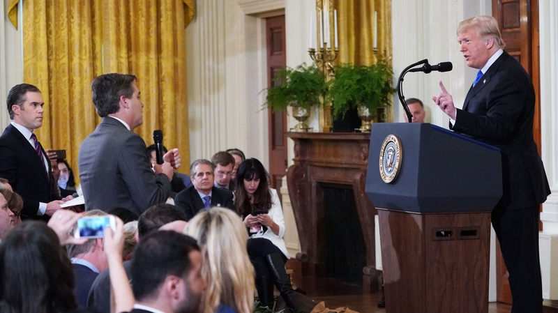 President Trump clashes with CNN journalist Jim Acosta (C) and NBC's Peter Alexander (L), who came to Mr Acosta's defence