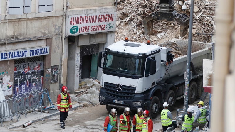 Rescue workers at the site where two dilapidated apartment buildings collapsed in Marseille