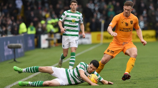 Lewis Morgan (L) of Celtic FC slips under pressure from Alan Lithgow