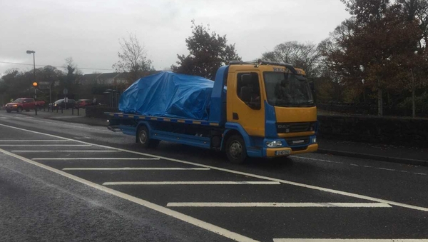 The car is taken away from the scene for a forensic examination